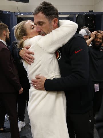 <p>Michael Zagaris/San Francisco 49ers/Getty</p> Kyle Shanahan and Mandy Shanahan in the locker room after the game against the Seattle Seahawks at Lumen Field on December 15, 2022.