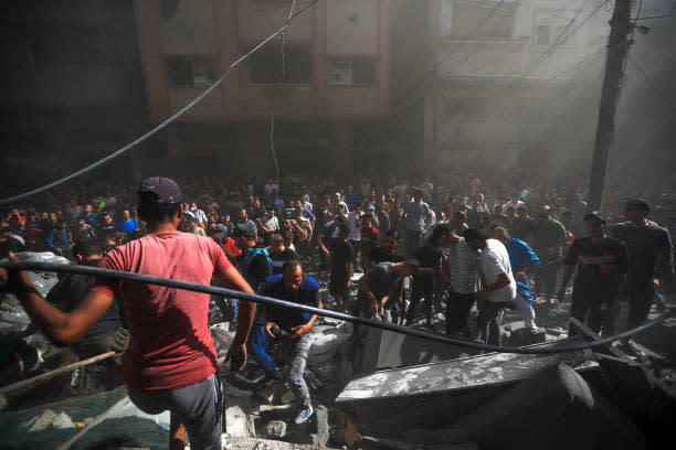 Civil defense teams and locals carry out search and rescue operations after an Israeli attack hits Shaqwra family apartment in Khan Yunis, Gaza on 6 November 2023 (Middle East Images/AFP via Getty)