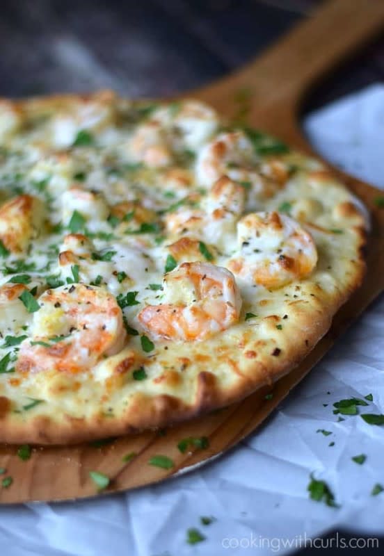 <p>Cooking with Curls</p><p>This shrimp scampi pizza is the perfect example of unexpected toppings taking ordinary ingredients to an extraordinary level.</p><p><strong>Get the recipe: <a href="https://cookingwithcurls.com/2015/02/09/shrimp-scampi-pizza/" rel="nofollow noopener" target="_blank" data-ylk="slk:Shrimp Scampi Pizza;elm:context_link;itc:0;sec:content-canvas" class="link ">Shrimp Scampi Pizza</a></strong></p>