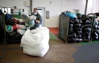 Bags of sorted clothing are packed into bales at the Green World Recycling facility in Stourbridge, Britain