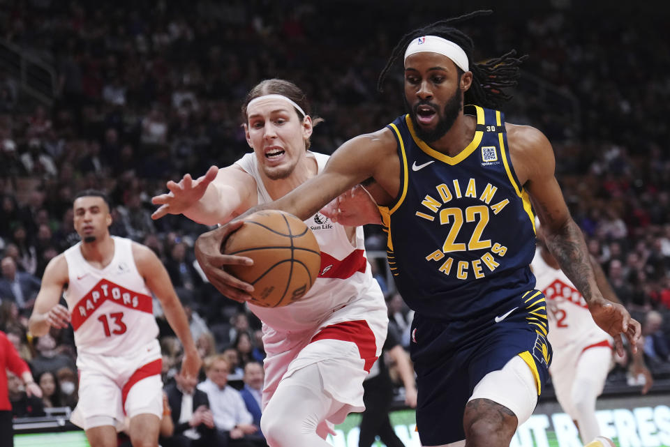 Indiana Pacers forward Isaiah Jackson (22) and Toronto Raptors forward Kelly Olynyk (41) reach for the ball during the first half of an NBA basketball game Tuesday, April 9, 2024, in Toronto. (Nathan Denette/The Canadian Press via AP)