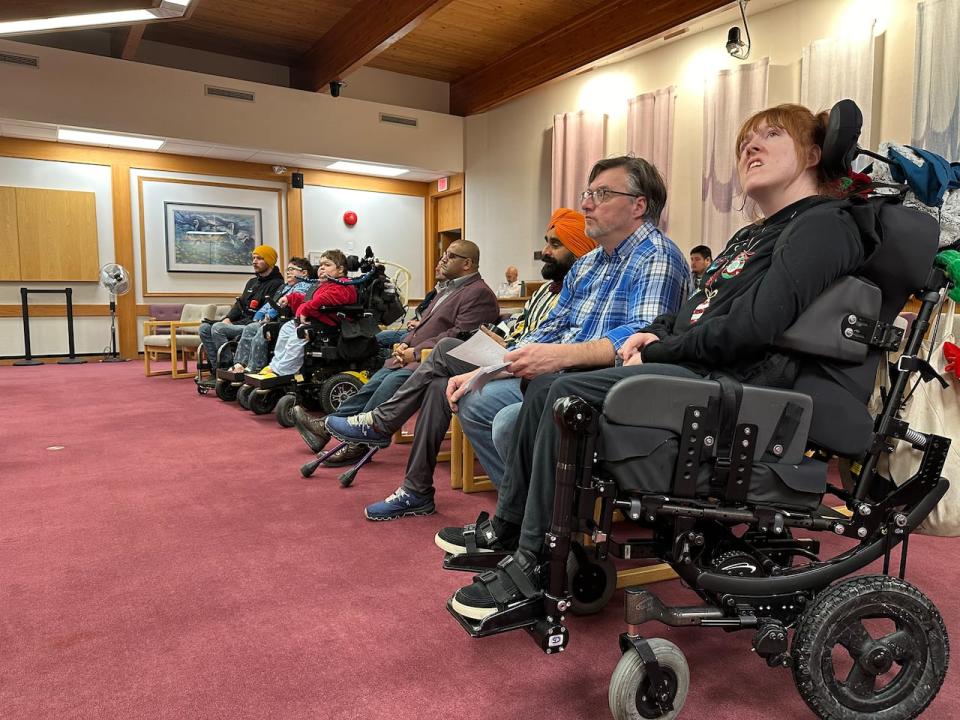 A group of advocates for better accessibility in downtown Whitehorse at a city council meeting on Monday. Council voted unanimously in favour of spending $220,000 this winter on snow and ice removal from parking spaces and other downtown infrastructure for people with mobility challenges.  (Cheryl Kawaja/CBC - image credit)