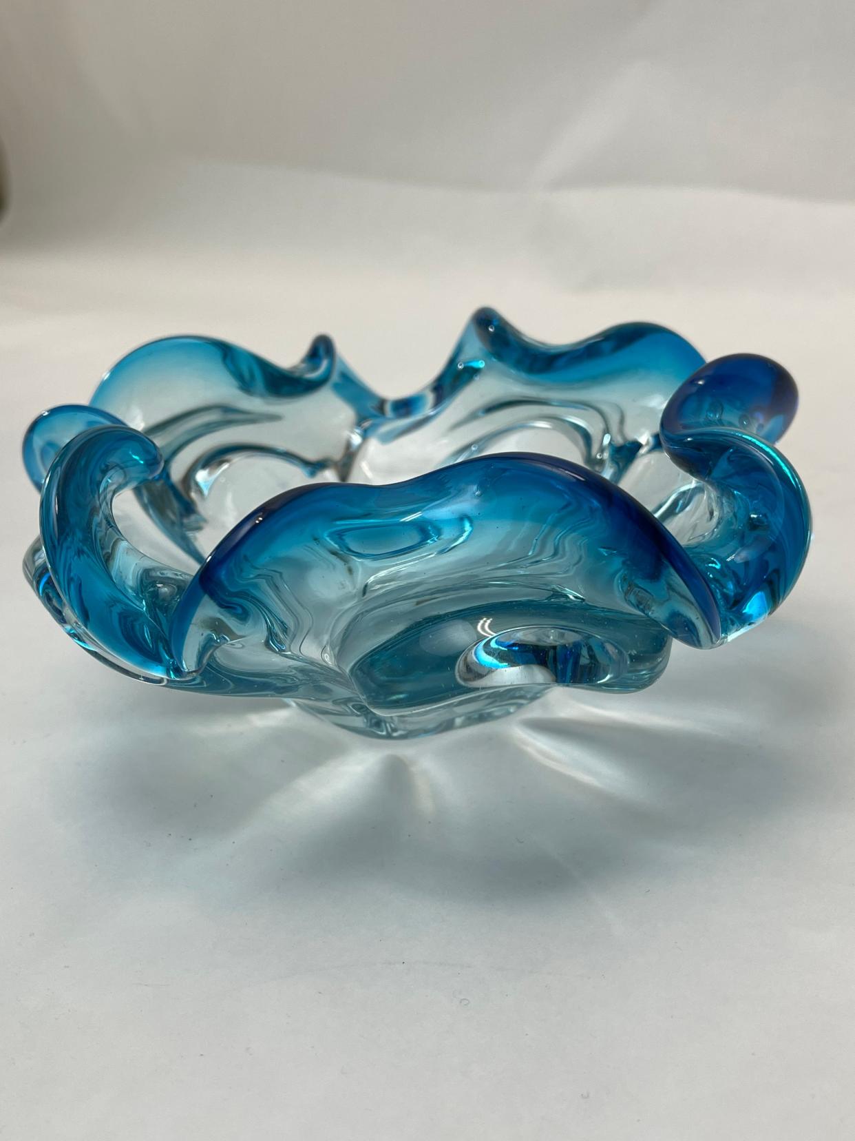 Multiple hues, flowing designs and internal bubbles are characteristic of Murano glass ($34).