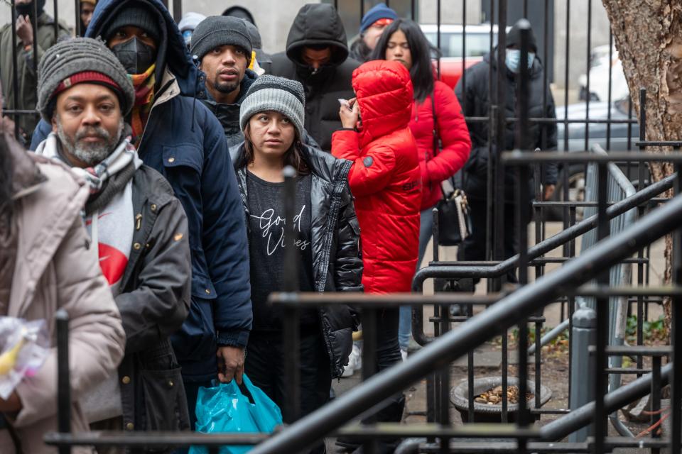 People, mostly newly arrived migrants, receive an afternoon meal from Trinity Services and Food For the Homeless, across from Tompkins Square Park on January 24, 2024 in New York City. T