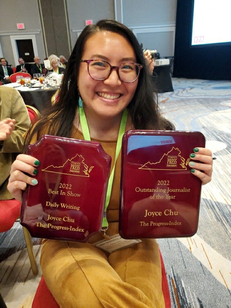 Joyce Chu displays her two major awards at the Virginia Press Association's annual banquet. She was named 2022 Outstanding Journalist of the Year, and her work won Best in Show for daily writing.