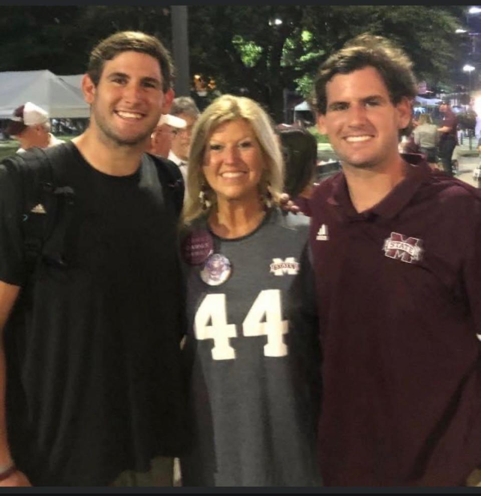 Mississippi State football linebacker Jett Johnson (left) poses for a photo after a game with his mother Frances Johnson and brother Tate Johnson.