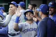 Toronto Blue Jays' Daulton Varsho celebrates with teammates after scoring against the Cincinnati Reds during the fourth inning of a baseball game Saturday, Aug. 19, 2023, in Cincinnati. (AP Photo/Joshua A. Bickel)