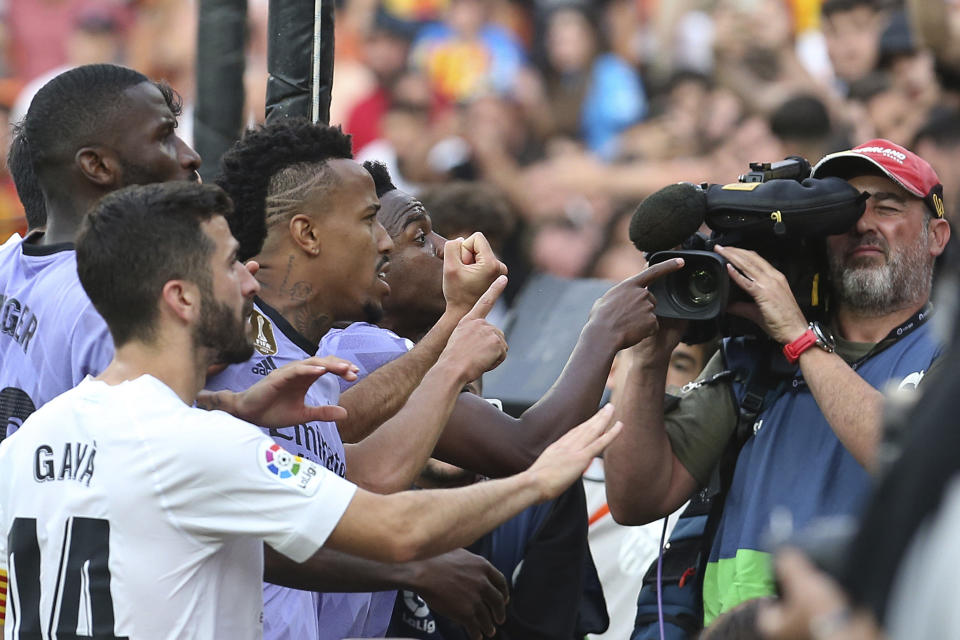 Real Madrid's Vinicius Junior, centre confronts Valencia fans along with some of his team mates during a Spanish La Liga soccer match between Valencia and Real Madrid, at the Mestalla stadium in Valencia, Spain, Sunday, May 21, 2023. The game was temporarily stopped when Vinicius said a fan had insulted him from the stands. He was later sent off after clashing with Valencia players. (AP Photo/Alberto Saiz)