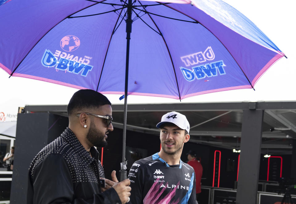 Alpine driver Pierre Gasly of France, right, walks with Canadian rapper Nav at the Canadian Grand Prix auto race Thursday, June 6, 2024, in Montreal. (Ryan Remiorz/The Canadian Press via AP)