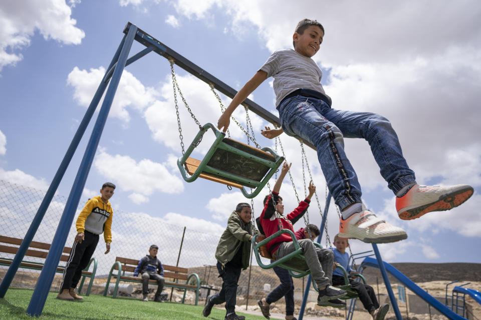 FILE - Palestinian children play at an entertainment facility in the West Bank Beduin community of Jinba, Masafer Yatta, Friday, May 6, 2022. The Israeli military has demolished homes, water tanks and olive orchards in two Palestinian villages in the southern West Bank where some residents are at risk of imminent expulsion, residents and activists said Wednesday, Jan. 4, 2023. (AP Photo/Nasser Nasser, File)
