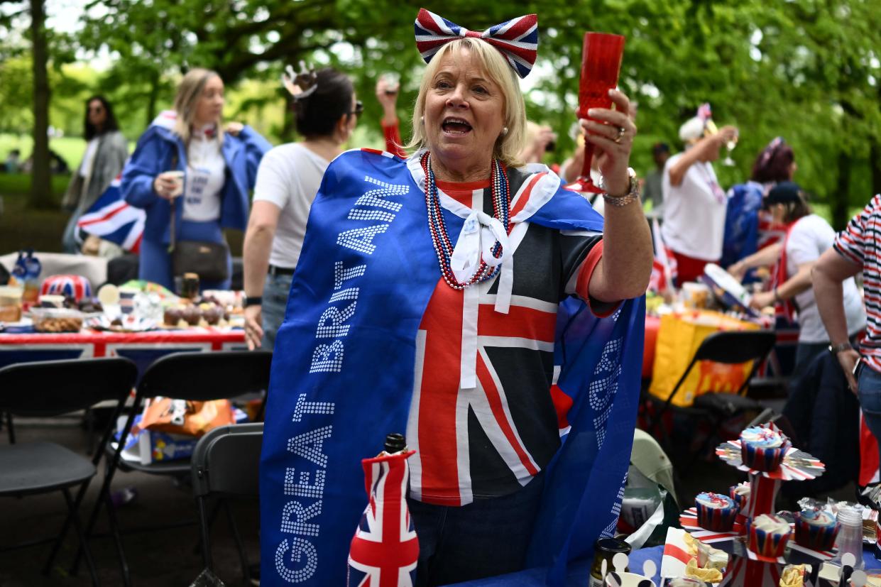 A royal fan wearing a Union flag outfit makes a toast to the king in London (AFP/Getty)