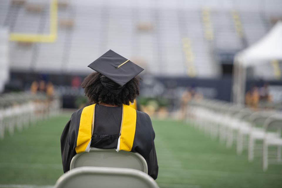 ATLANTA, GEORGIA - DECEMBER 12: Georgia Tech graduate attends the fall commencement at Bobby Dodd Stadium on December 12, 2020 in Atlanta, Georgia. Because of social distancing mandates instituted by the state to curtail the spread of COVID-19, graduates received their degrees in a nearly-empty stadium with a few family or relatives in attendance. (Photo by Marcus Ingram/Getty Images)