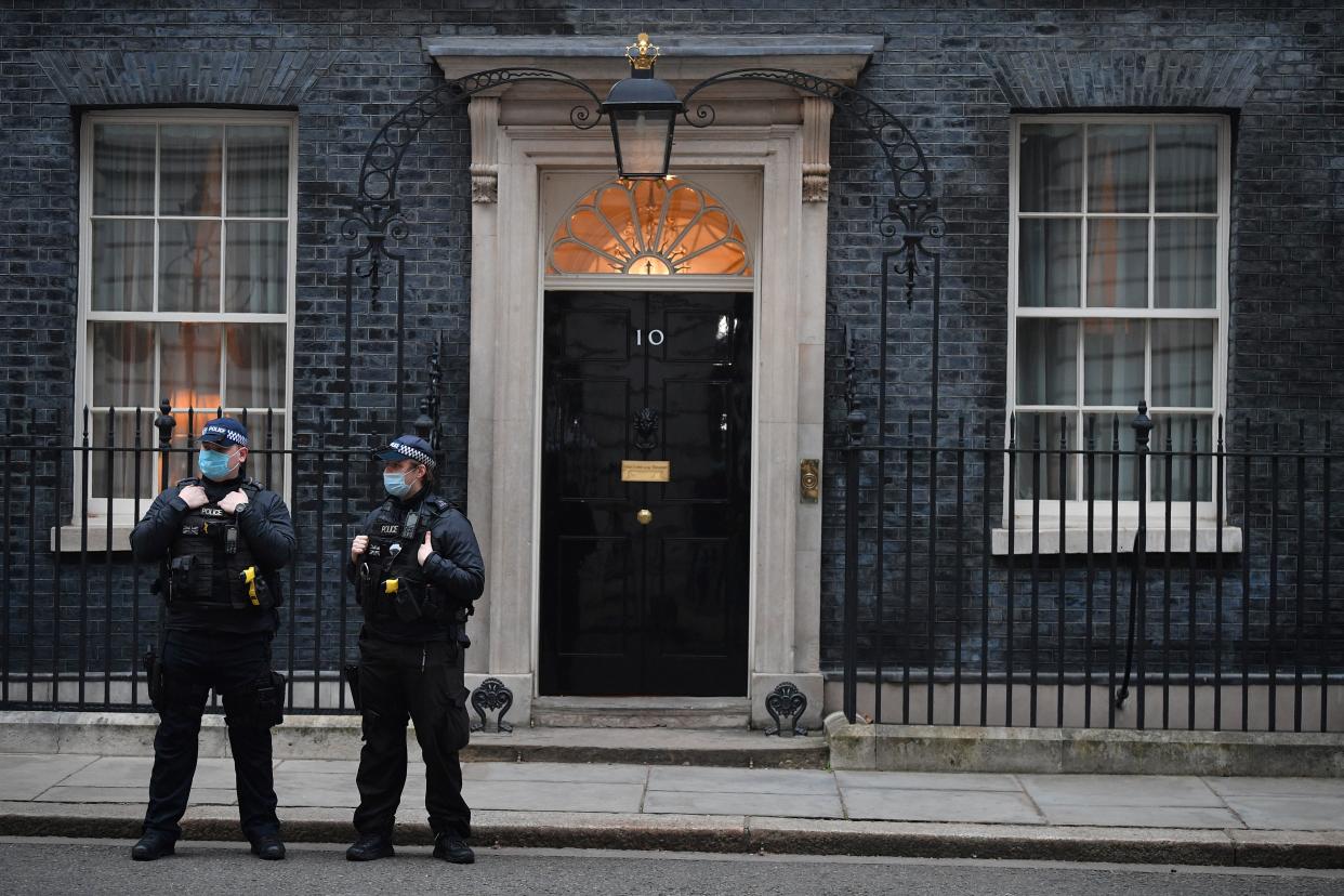 Police stand guard outside 10 Downing street in central London on March 3, 2021. - Britain is expected to keep vast emergency financial support propping up the UK's virus-battered economy when unveiling its annual budget today, but could also raise tax to fight surging debt. (Photo by JUSTIN TALLIS / AFP) (Photo by JUSTIN TALLIS/AFP via Getty Images)
