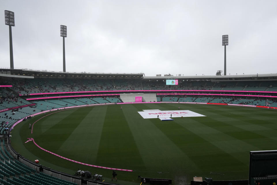 The covers are on the wicket as rain falls before play on the third day of the cricket test match between Australia and South Africa at the Sydney Cricket Ground in Sydney, Friday, Jan. 6, 2023. (AP Photo/Rick Rycroft)