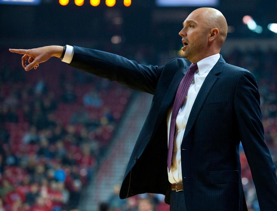 New Mexico Highlands head coach Craig Snow points to a player on the floor during a game against UNLV at Thomas & Mack Center in 2015.