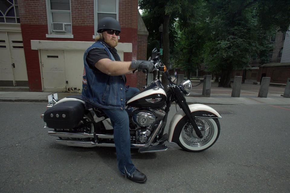 Stan Ellsworth sits a on motorcycle.