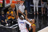Los Angeles Clippers guard Reggie Jackson (1) goes to the basket as Utah Jazz center Rudy Gobert, right, defends during the second half of Game 5 of a second-round NBA basketball playoff series Wednesday, June 16, 2021, in Salt Lake City. (AP Photo/Rick Bowmer)