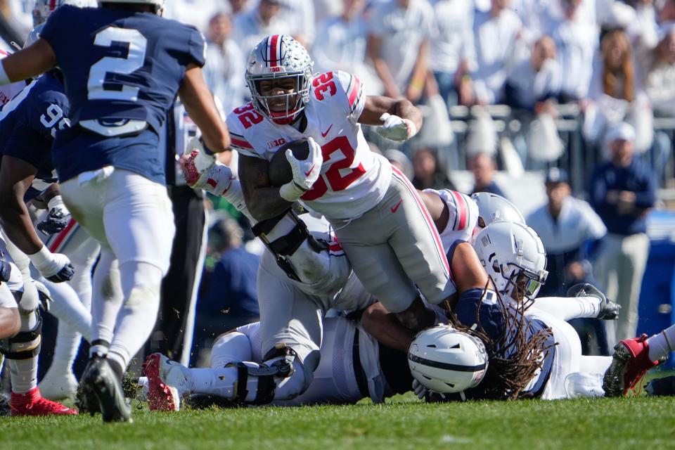 Ohio State running back TreVeyon Henderson runs the ball against Penn State.