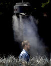 <p>A man stands under a misting machine, June 19, 2017 in Tempe, Ariz. The forecast calls for a high of 118 on Monday and 120 on Tuesday in Phoenix. (Matt York/AP) </p>