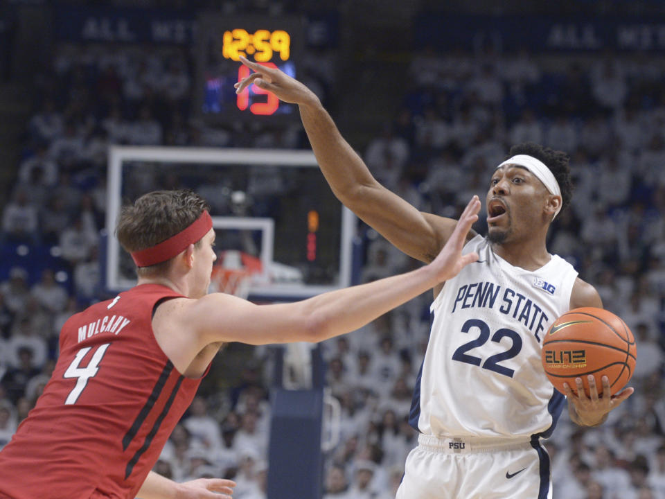 Penn State's Jalen Pickett (22) calls out a play as Rutgers' Paul Mulcahy (4) defends during the first half of an NCAA college basketball game, Sunday, Feb. 26, 2023, in State College, Pa. (AP Photo/Gary M. Baranec)