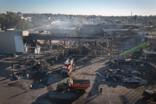 Ukrainian State Emergency Service firefighters work to take away debris at a shopping center burned after a rocket attack in Kremenchuk, Ukraine, on June 28, 2022. (Photo: Efrem Lukatsky via Associated Press)