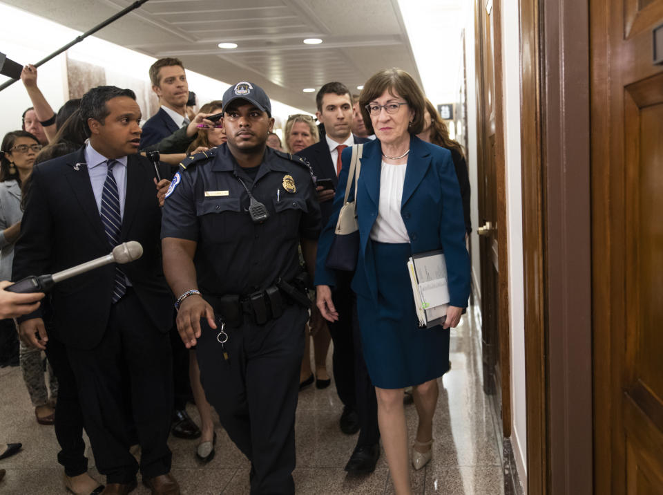 Sen. Susan Collins, R-Maine, is escorted by U.S. Capitol Police as reporters ask about Supreme Court nominee Brett Kavanaugh on Capitol Hill in Washington on Wednesday. (Photo: J. Scott Applewhite/AP)