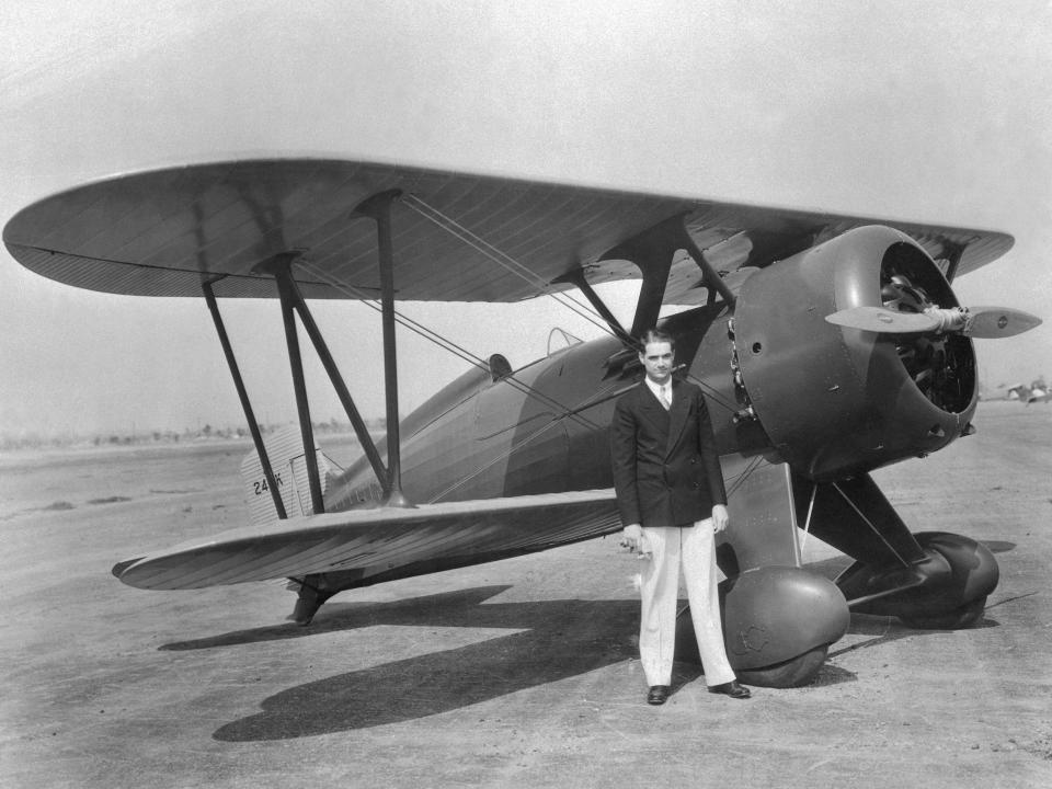 Howard Hughes, motion picture producer, shown after a test hop in his new high powered plane, a Boeing Army pursuit ship.