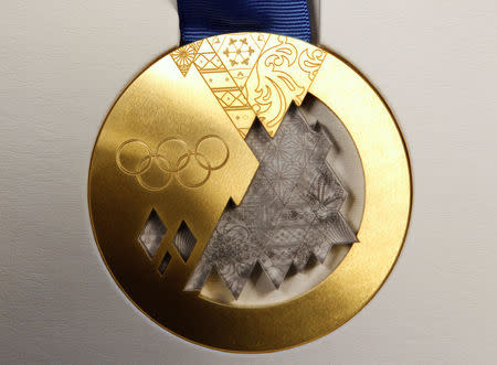 The gold medal for the 2014 Winter Olympic Games in Sochi is seen on display during a presentation in St. Petersburg May 30, 2013. REUTERS/Alexander Demianchuk/File Photo