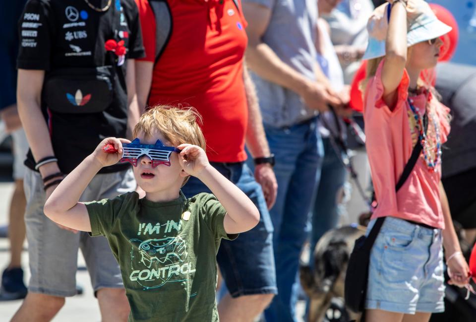 A young spectator watches for planes during the Memorial Day Air Fair & Flower Drop at the Palm Springs Air Museum in Palm Springs, Calif., Monday, May 29, 2023. 