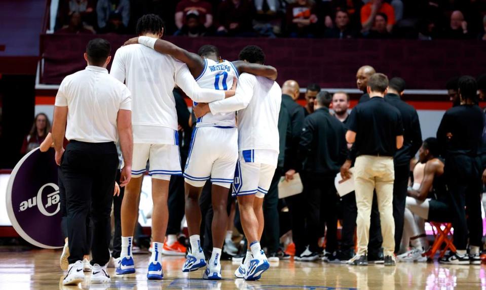 Duke’s Christian Reeves, left, and Kale Catchings help Dariq Whitehead (0) off the court after he was injured during the second half of Virginia Tech’s 78-75 victory over Duke at Cassell Coliseum in Blacksburg, VA., Monday, Jan. 23, 2023.