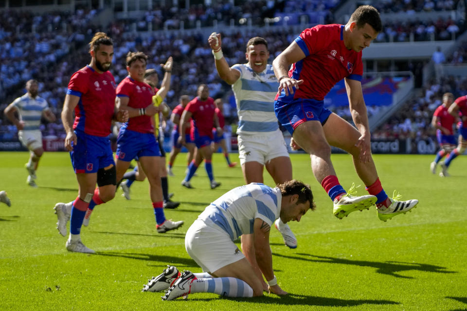 Argentina's Nicolas Sanchez, bottom, celebrates scoring his side's first try against Chile during a Rugby World Cup Pool D at the Stade de la Beaujoire in Nantes, France, Saturday, Sept. 30, 2023. (AP Photo/Themba Hadebe)