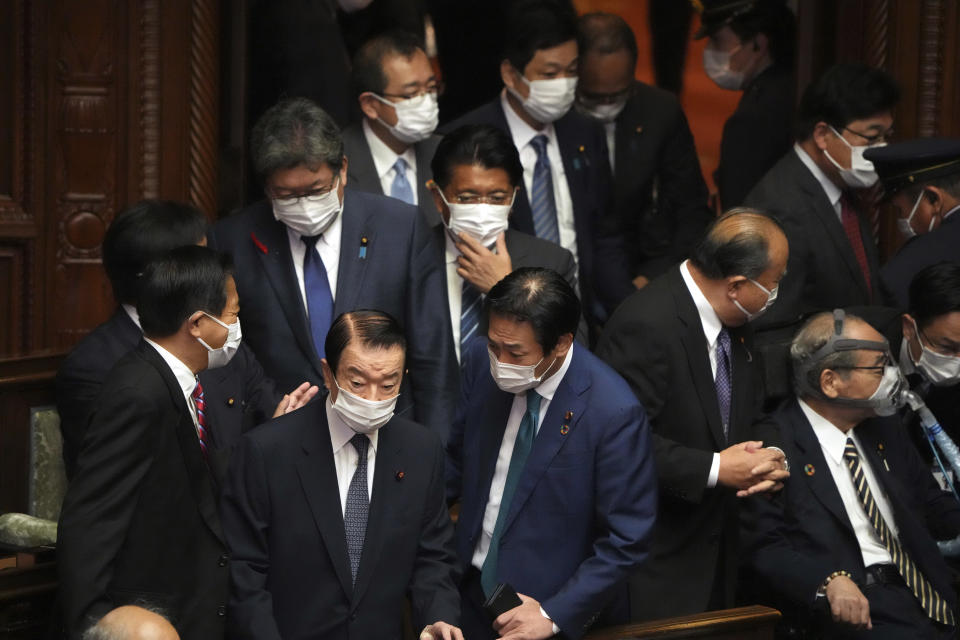 Lawmakers walk in an extraordinary Diet session at the lower house of parliament before the lower house was dissolved, Thursday, Oct. 14, 2021, in Tokyo. Japan’s new Prime Minister Fumio Kishida dissolved the lower house of parliament Thursday, paving the way for Oct. 31 national elections.(AP Photo/Eugene Hoshiko)