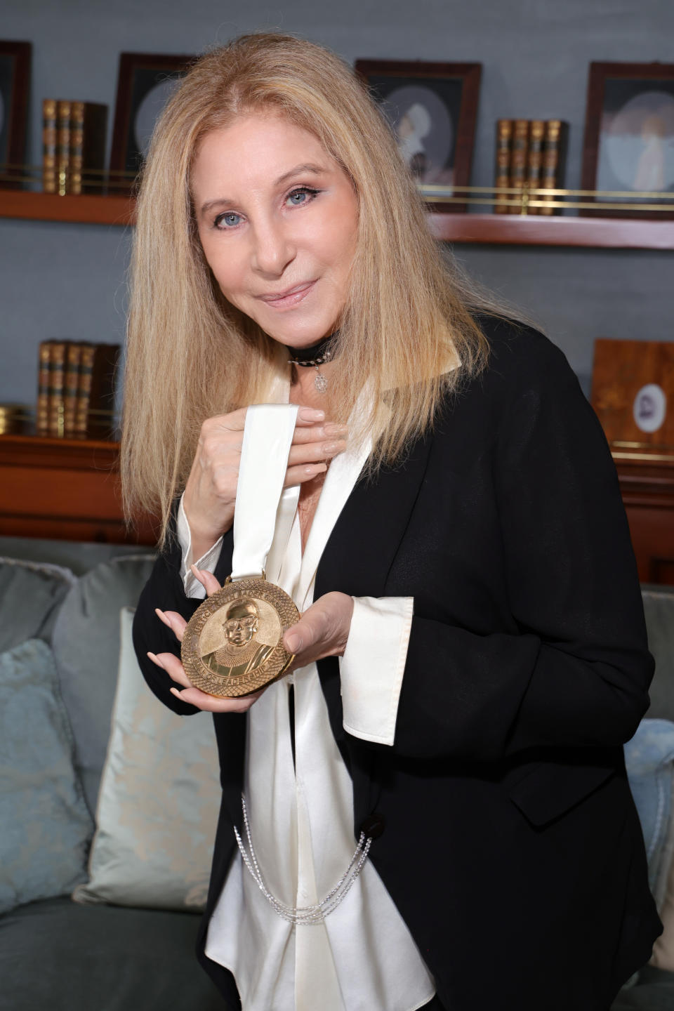 closeup of her holding a medal