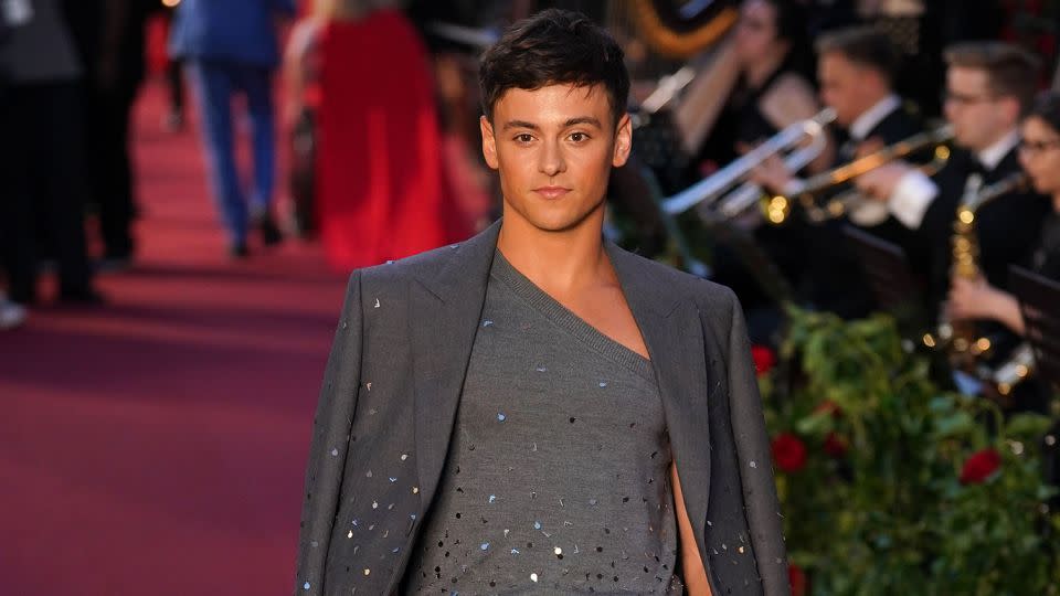 Olympic diver Tom Daley wore an asymmetric top under his playful gray suit. - Yui Mok - PA Images/Getty Images