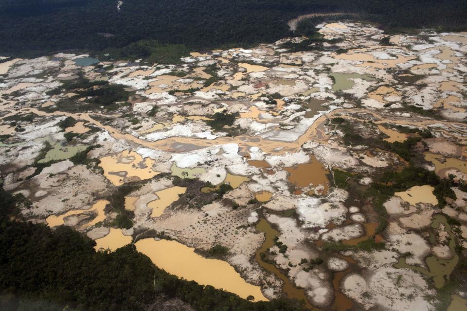 FILE - This Sept. 13, 2013 aerial file photo, shows tailings produced by informal mining in Peru's Madre de Dios region. The clock has run out for an estimated 40,000 illegal gold miners who had until Saturday to legalize their status in a region of southeastern Peru where fortune-seekers have ravaged rainforests and contaminated rivers. But officials insist this time they’re serious about combatting the multi-billion-dollar illegal mining trade that accounts for about 20 percent of Peru’s gold exports. (AP Photo/Rodrigo Abd, File)