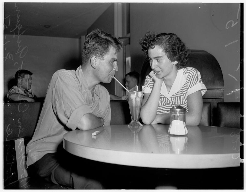 Lovebirds share a milkshake: 1951