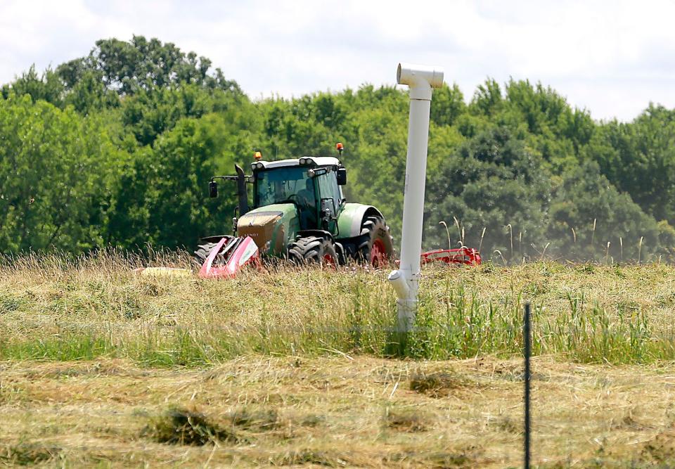 Grass is mowed Thursday at the old Ashland County Landfill at Byers Woods. Commissioners have approved an additional $23,000 for gas monitoring at the site.