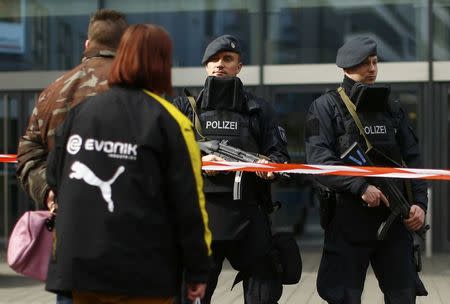 People passing-by talk to police at the Limbecker Platz shopping mall in Essen, Germany, March 11, 2017, after it was shut due to attack threat. REUTERS/Thilo Schmuelgen