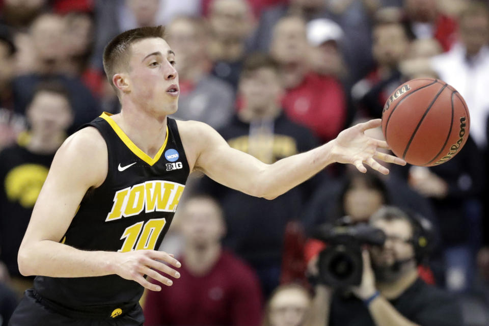 FILE- In this March 22, 2019, file photo, Iowa's Joe Wieskamp passes the ball against Cincinnati in the second half during a first-round men's college basketball game in the NCAA Tournament in Columbus, Ohio, Friday,. Returning starters Joe Wieskamp and Luka Garza headline a roster that is deep at every position. (AP Photo/Tony Dejak, File)