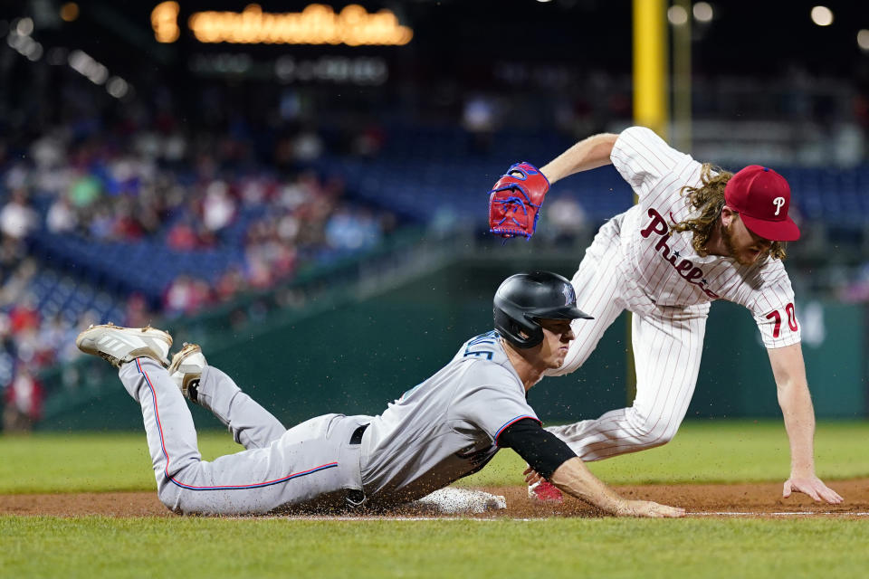 Miami Marlins' Joey Wendle, left, cannot beat Philadelphia Phillies pitcher Bailey Falter to first base on a ground out during the sixth inning of a baseball game, Wednesday, Sept. 7, 2022, in Philadelphia. (AP Photo/Matt Slocum)