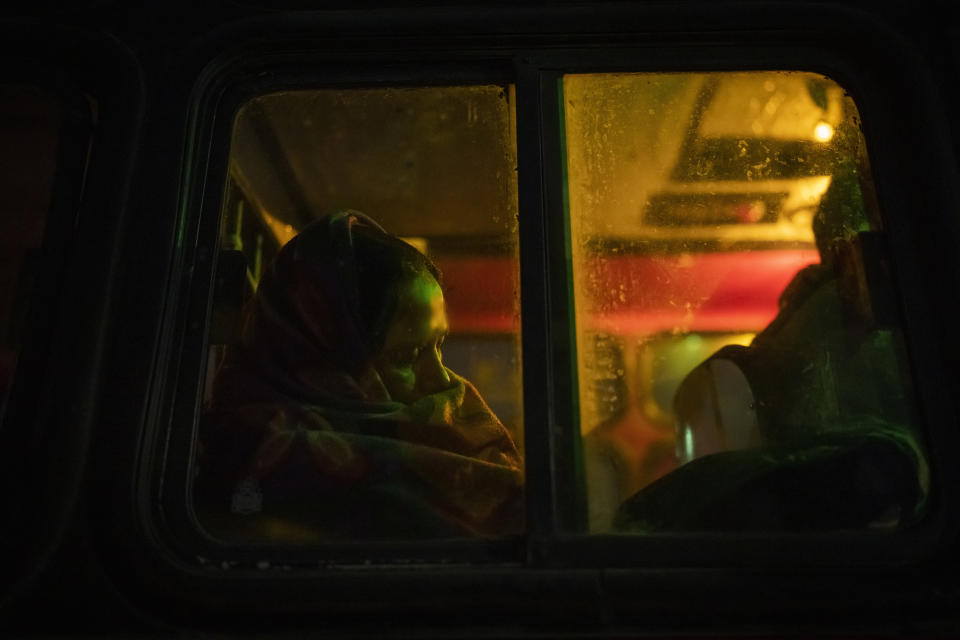 An Indian pilgrim sleeps inside a bus as she waits for its departure after visiting Pashupatinath temple in Kathmandu, Nepal, Jan. 12, 2024. The centuries-old temple is one of the most important pilgrimage sites in Asia for Hindus. Nepal and India are the world’s two Hindu-majority nations and share a strong religious affinity. Every year, millions of Nepalese and Indians visit Hindu shrines in both countries to pray for success and the well-being of their loved ones. (AP Photo/Niranjan Shrestha)