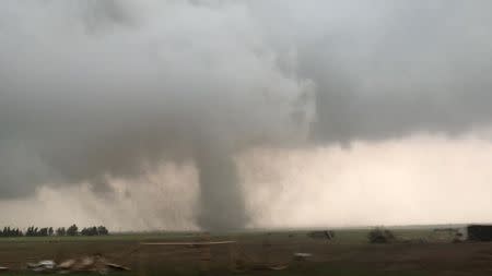 A tornado spins during stormy weather in Mangum, Oklahoma, U.S., May 20, 2019, in this still image taken from video from social media. Lorraine Matti via REUTERS