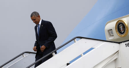 U.S. President Barack Obama steps out from Air Force One upon his arrival in Brussels June 4, 2014. Obama will attend the G7 meeting. REUTERS/Kevin Lamarque