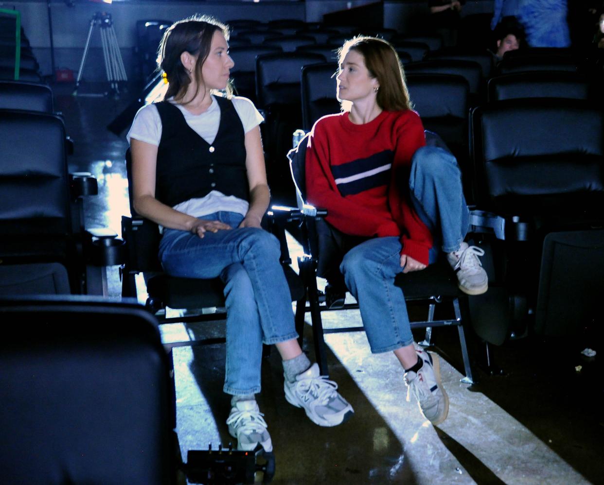 Alexandria Swarens, left, wrote, directed and starred in "The Holiday Club," filmed in Ashland. Mak Healy also starred in the film. They are waiting to review the scene they just filmed on the their last day of shooting at The Ashland Theatre.