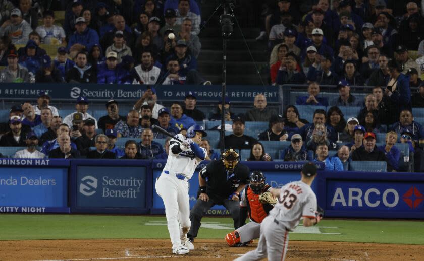 Los Angeles, CA - April 03: Dodgers designated hitter Shohei Ohtani, #17, hits his first home run off of Giants pitcher Taylor Rogers, # 33, in the seventh inning at Dodger Stadium in Los Angeles Wednesday, April 3, 2024. (Allen J. Schaben / Los Angeles Times)