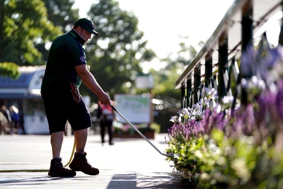 Ground staff water flowers outside of Centre Court ahead of day one of the 2022 Wimbledon Championships (Zac Goodwin/PA) (PA Wire)