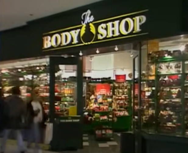 Exterior view of The Body Shop storefront in a mall, with visible products inside