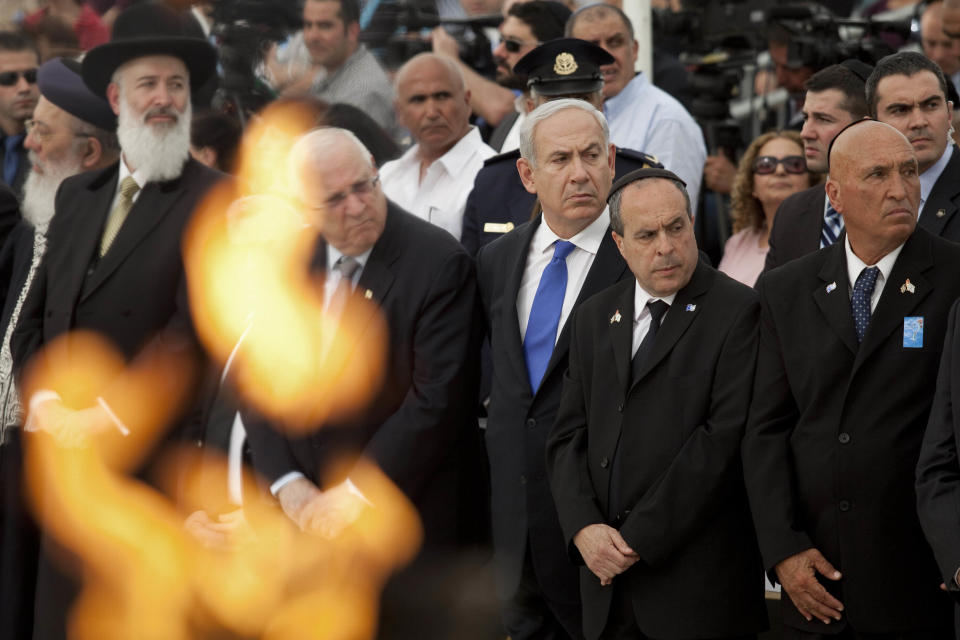 Israeli Prime Minister Benjamin Netanyahu, center, attends a state memorial ceremony on Remembrance Day for the fallen soldiers of Israel's wars, in Yad Lebanim soldiers Memorial in Jerusalem, Tuesday, April 24, 2012. (AP Photo/Abir Sultan, Pool)