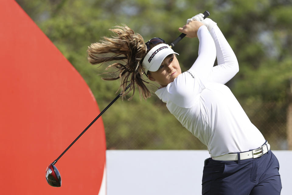 Brook M. Henderson watches her tee shot on the 16th hole during the first round of the LPGA golf tournament Wednesday, April 12, 2023, near Honolulu. (AP Photo/Marco Garcia)