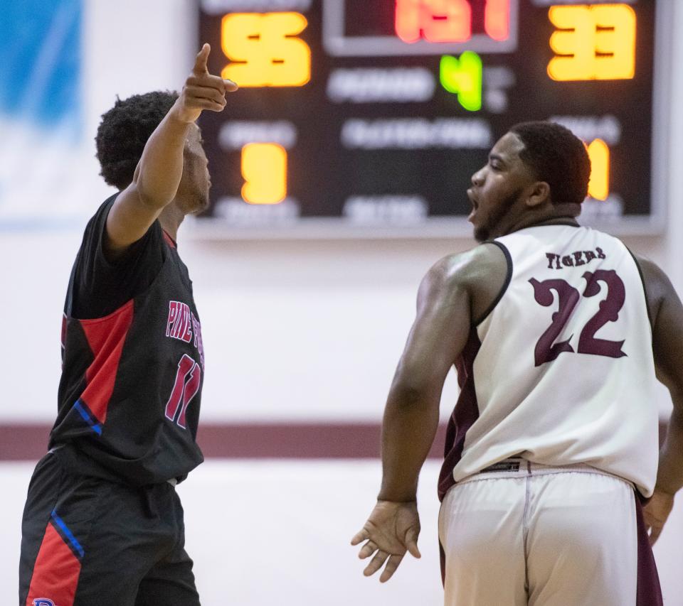 Cachaz Alfred (11) tells Felton Roberson (22) to check out the score as they exchange words during the Pine Forest vs PHS boys basketball game at Pensacola High School on Friday, Jan. 14, 2022.